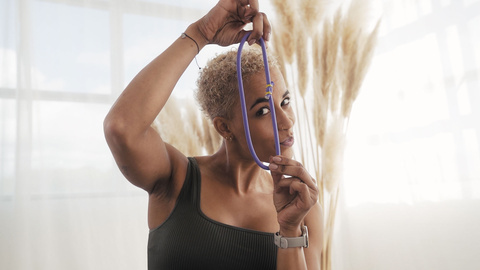 A woman showing a single purple bungee.